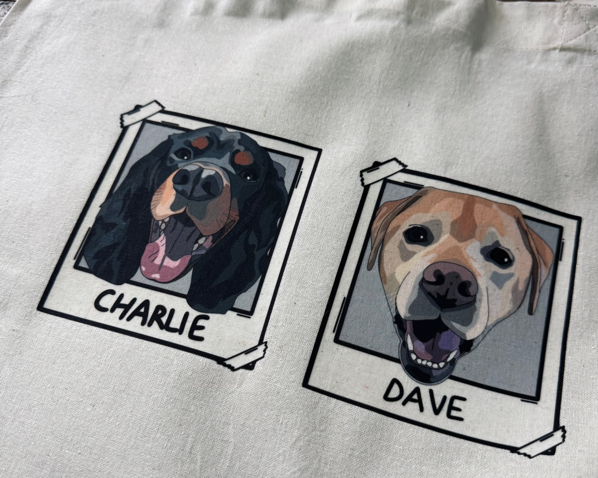 Tote bag with illustrations of dogs named Charlie and Dave on a wooden surface.