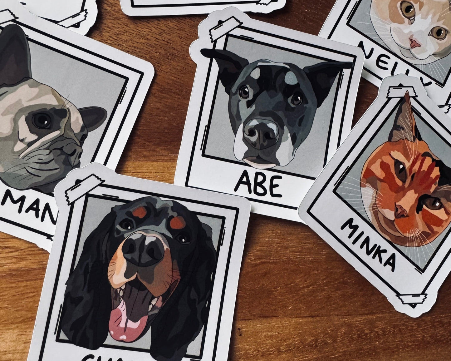Stickers of dogs and cats with names on a wooden surface