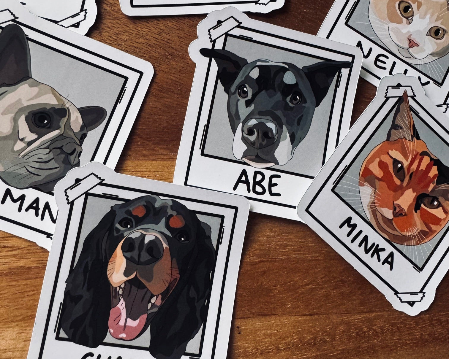 Stickers of dogs and cats with names on a wooden surface
