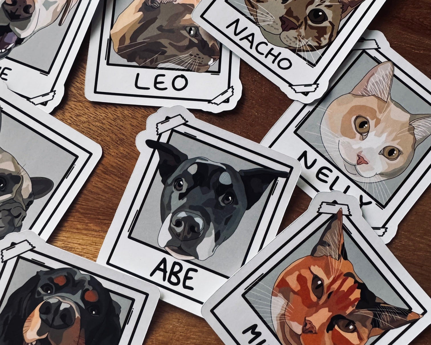 Stickers of dogs and cats with names on a wooden surface