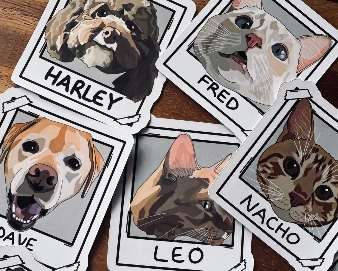 Stickers of dogs with names on a wooden surface
