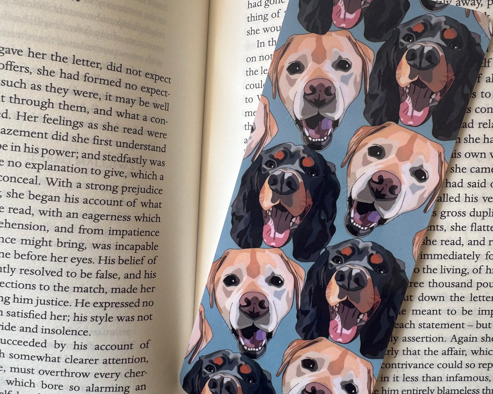 Book with a dog-themed bookmark featuring illustrations of dogs' faces.
