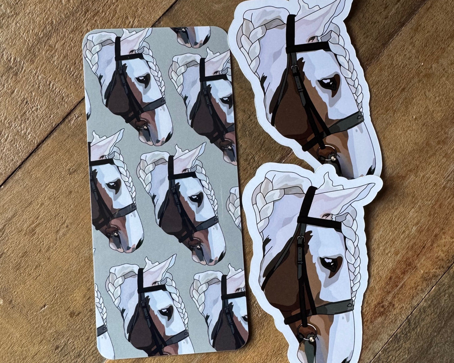 Two stickers with horse designs on a wooden surface