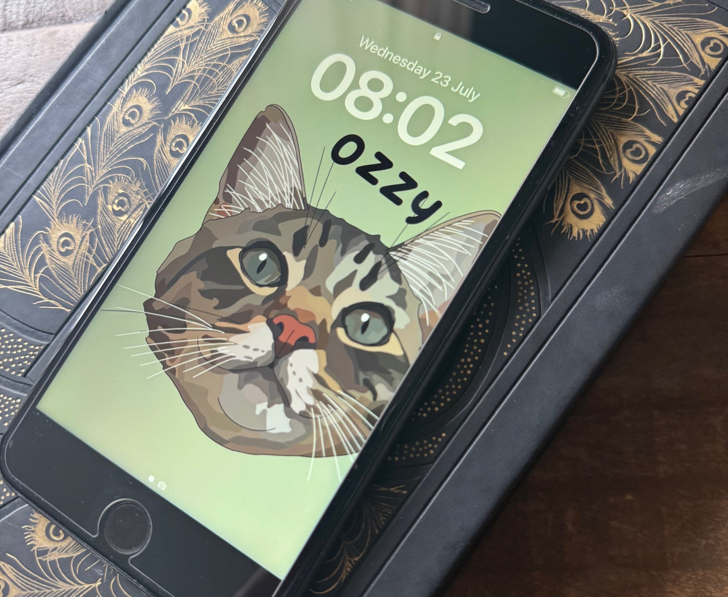 Phone with a cat-themed app on a decorative surface